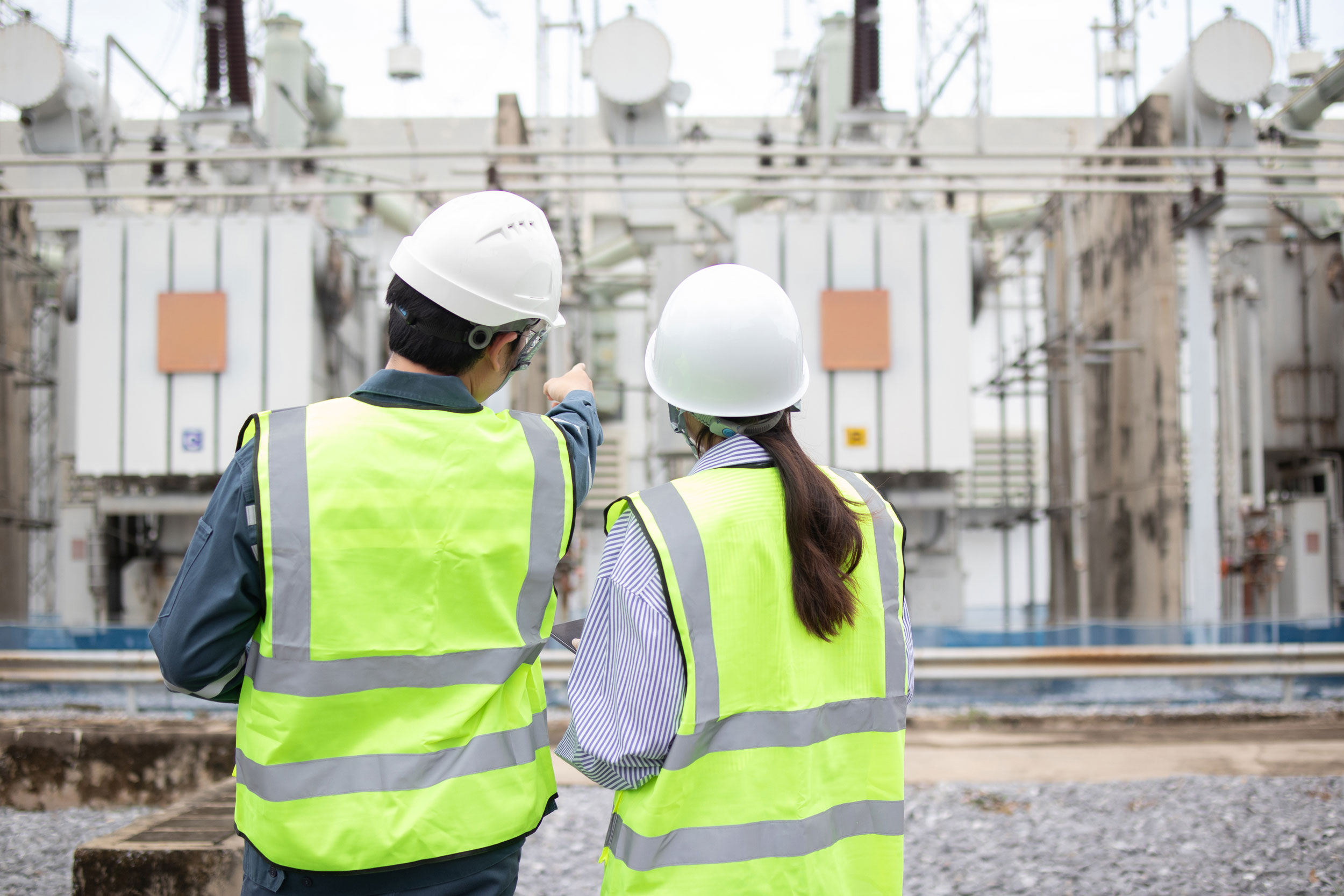 employees examining industrial plant